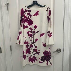 Gorgeous creamy white flutter sleeve dress with magenta floral pattern.